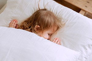 How to Get a Toddler To Sleep Through the Night (even in their own bed!)